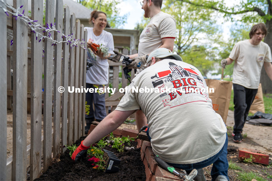 Members of Delta Phi Fraternity interact with homeowner Angel Mendoza as they plant her fairy garden during the Big Event. May 4, 2024. Photo by Kirk Rangel for University Communication.